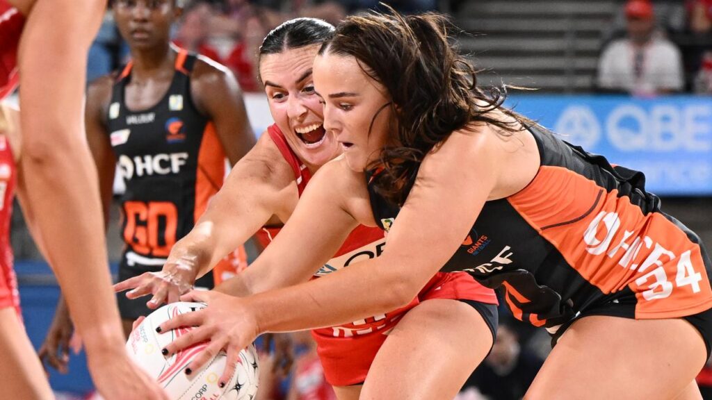The Swifts’ Maddy Proud (c) and Giants’ Hope White contest possession in the Super Netball derby.
