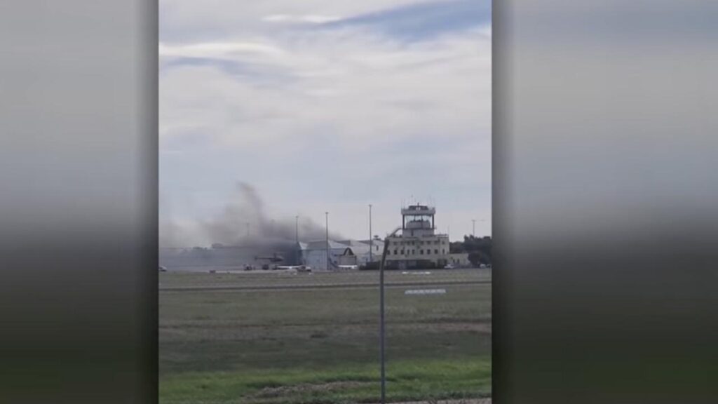 A flying instructor and student have died after a plane crashed into a hangar, authorities confirm.
