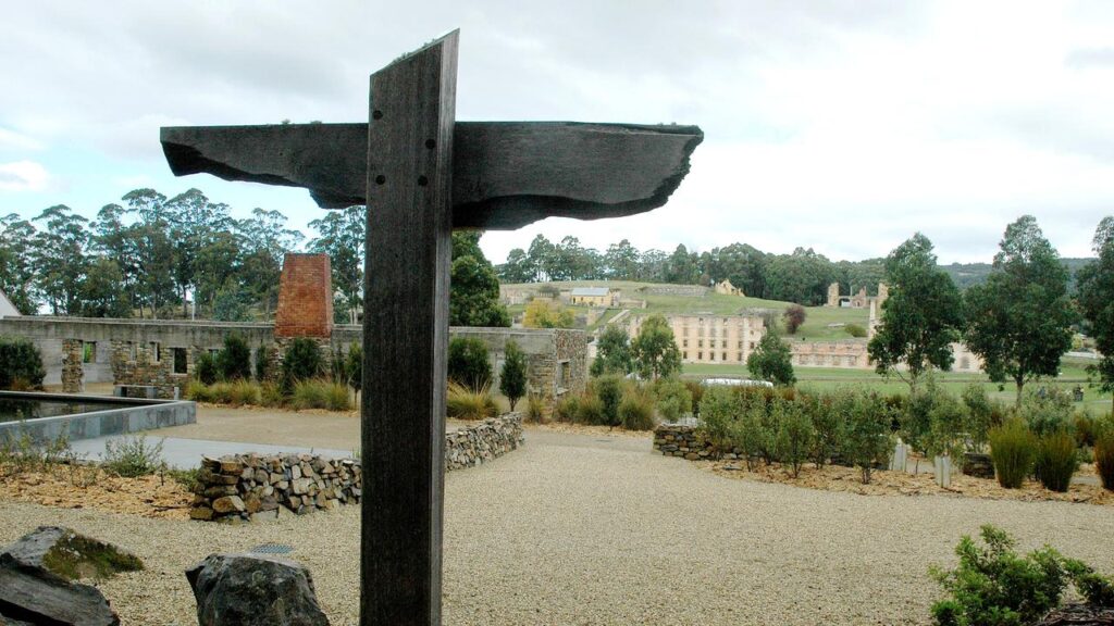A memorial to the victims of the Port Arthur massacre stands near the shell of the Broad Arrow Cafe.
