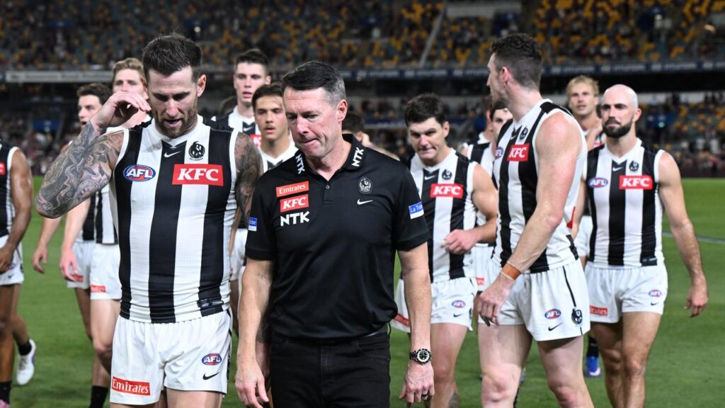 Collingwood coach Craig McRae with his defeated crew after a 54-point mauling by the Lions.
