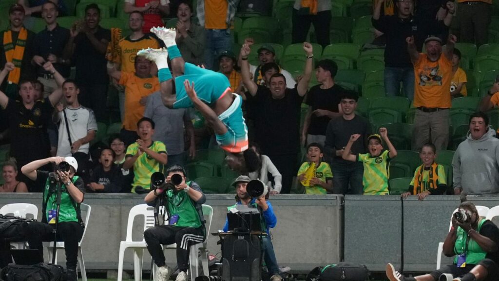 Australia’s Nestory Irankunda gets airborne after scoring his side’s fourth goal against Curacao.

