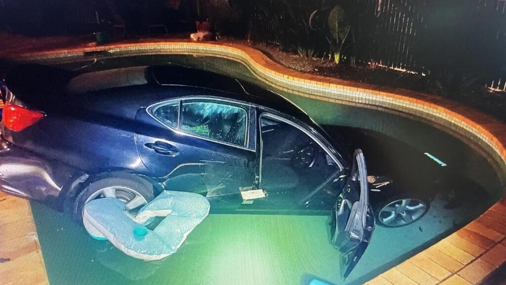 A man has been arrested and taken to hospital after driving a stolen car into the owner’s pool.
