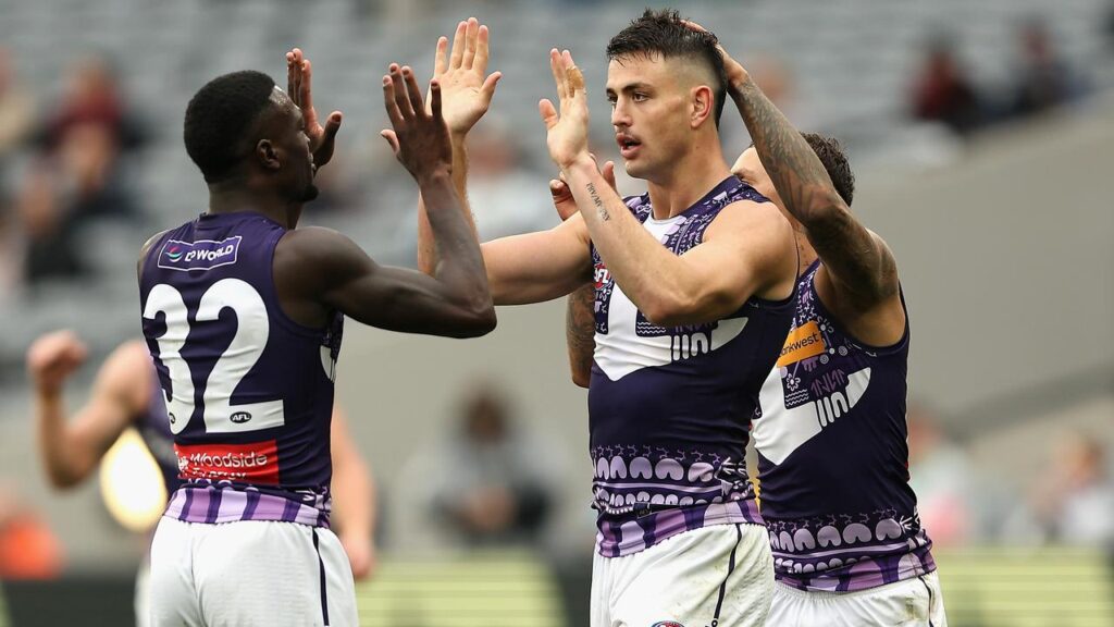 High fives: Patrick Voss led the goalscorers as Fremantle buried Essendon at a sparsely-filled MCG.
