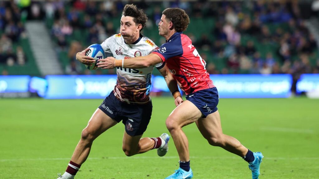 The Reds’ Jock Campbell surges upfield before being tackled by Western Force’s Max Burey.
