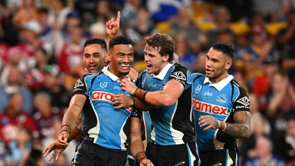 Ronaldo Mulitalo is the toast of the Sharks after scoring against the Bulldogs at Suncorp Stadium.
