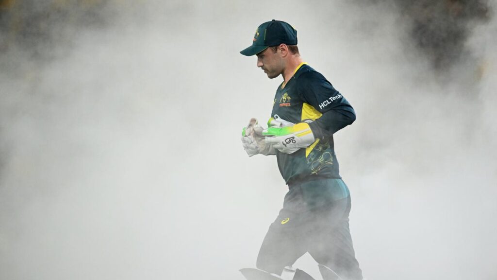 Josh Inglis runs out to lead Australia in the field against Pakistan at The Gabba in 2014.
