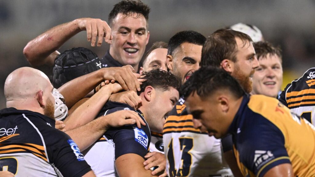Brumbies players celebrate a try by debutant Chris Mickelson (c) in their win over Western Force.  
