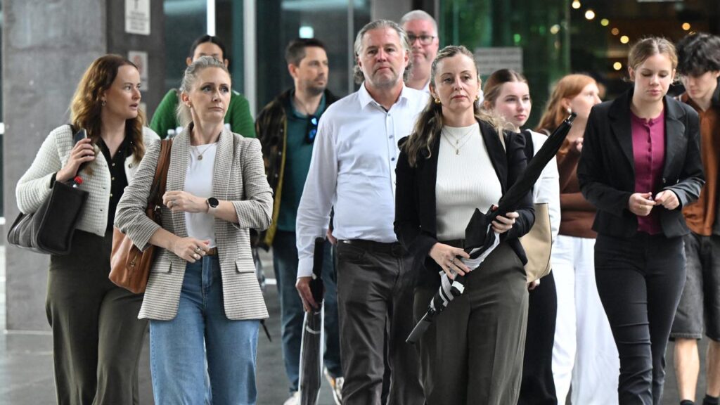 Rhianne Jones (holding umbrella) and family attended the first day of her husband’s inquest.
