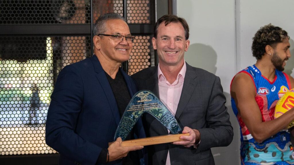 AFL boss Andrew Dillon makes a presentation to Michael McLean ahead of the Sir Doug Nicholls round.
