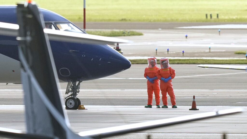 Dutch medical personnel in hazmat suits waited for patients taken from the MV Hondius cruise ship.
