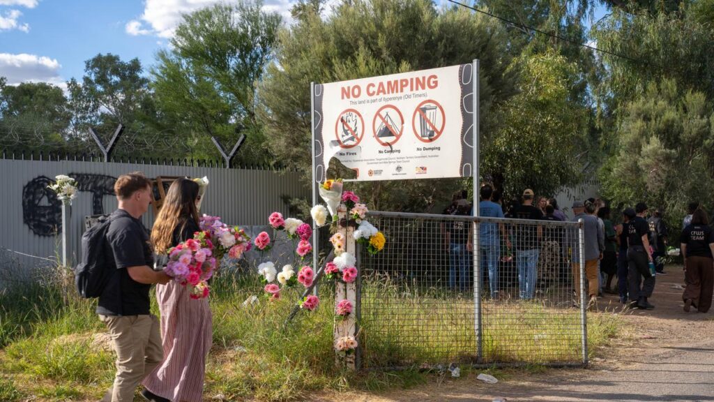 Alice Springs residents placed floral tribures at the Old Timers Camp where the girl disappeared.
