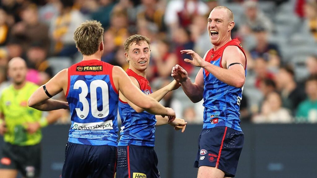 Harrison Petty (right) booted three goals as the Demons cruised to a 39-point win over Hawthorn.
