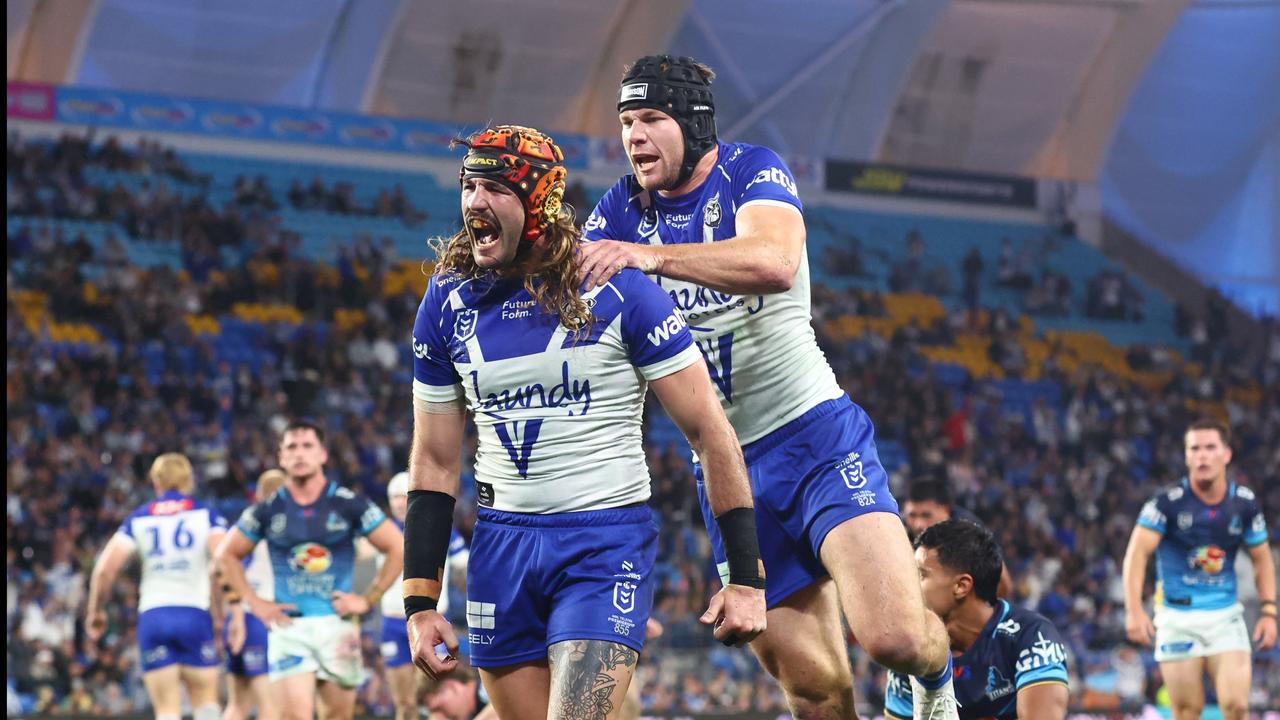 Josh Curran of the Bulldogs celebrates scoring a try with Matt Burton