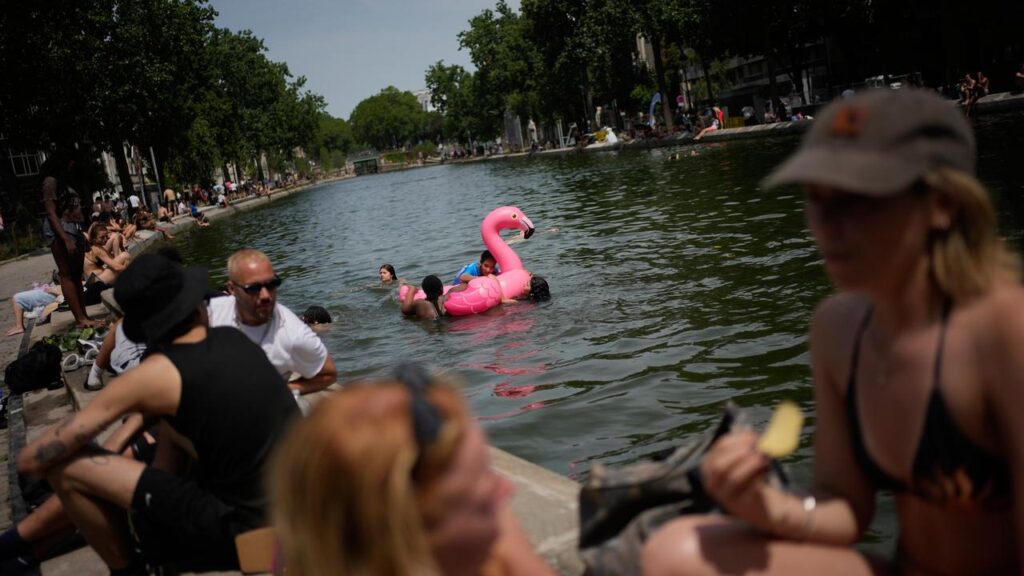 Parisians are cooling off however they can as western Europe endures a spell of blistering heat.
