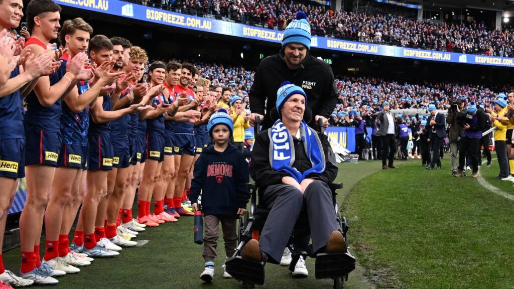Players form a guard of honour for Neale Daniher last year before the King’s Birthday clash. 

