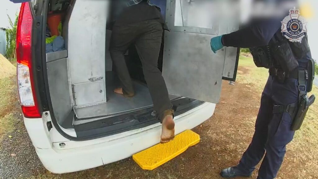 A man steps into a police van after being charged with the murder and torture of a baby boy.
