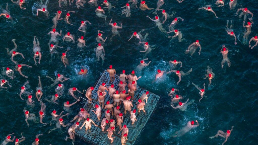 Swimmers participate in the annual nude winter solstice swim during Hobart’s Dark Mofo festival.
