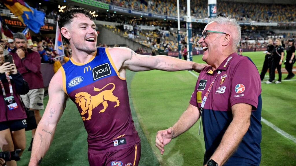 Lachie Neale, enjoying himself with Lions coach Chris Fagan, is weighing up his future at Brisbane.
