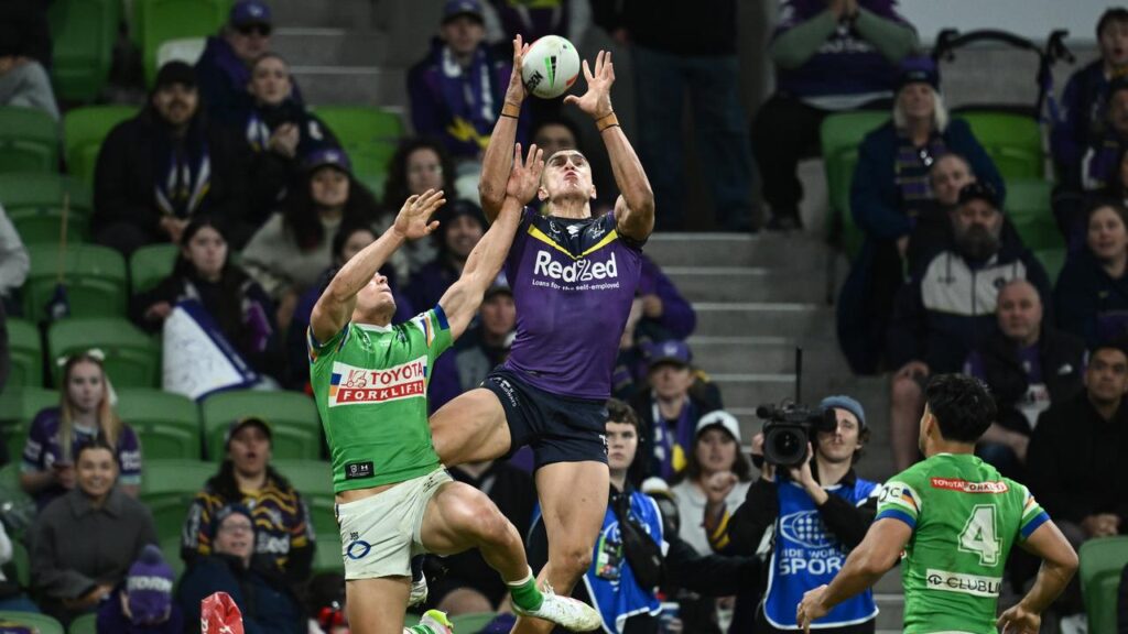 Will Warbrick climbs high to score one of his three tries to help the Storm overcome the Raiders.
