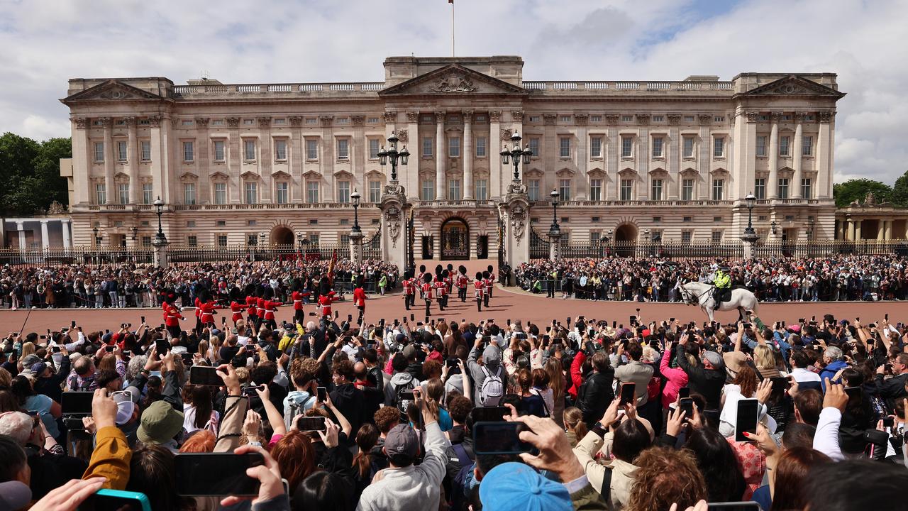 Tourists gather outside Buckingham Palace in London, Britain