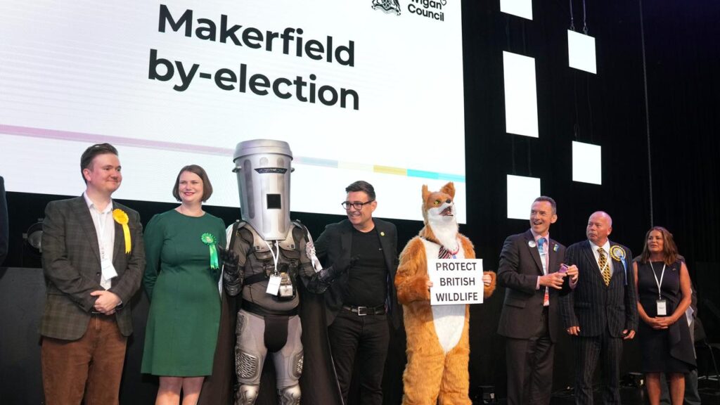 Labour party candidate Andy Burnham, centre, has won the crucial Makerfield by-election in the UK.
