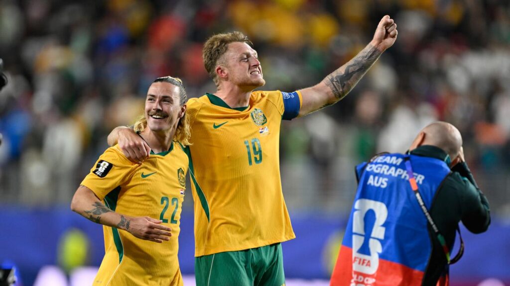 Australia’s Harry Souttar (19) and Jackson Irvine (22) celebrate reaching the World Cup’s last 32.
