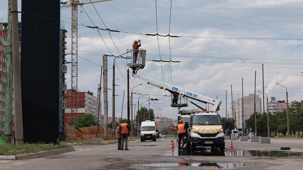 Municipal workers install anti drone nets