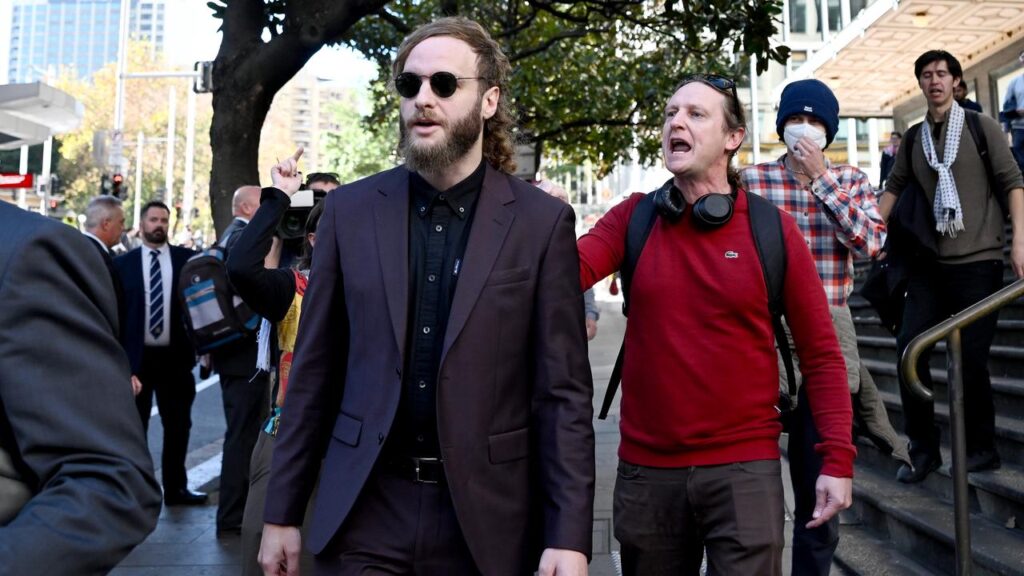 Pro-Palestine protesters chanted “Nazi scum” as Joel Davis (left) departed from court.
