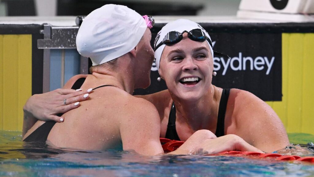 Shayna Jack (r) beams after earning a Commonwealth Games berth with third in the 100m freestyle. 
