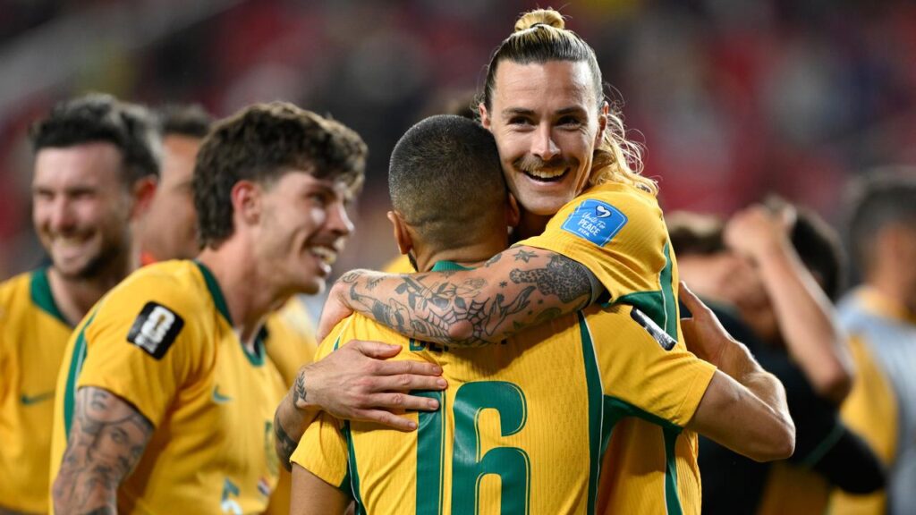 Jackson Irvine and the Socceroos celebrate the crucial draw with Paraguay.

