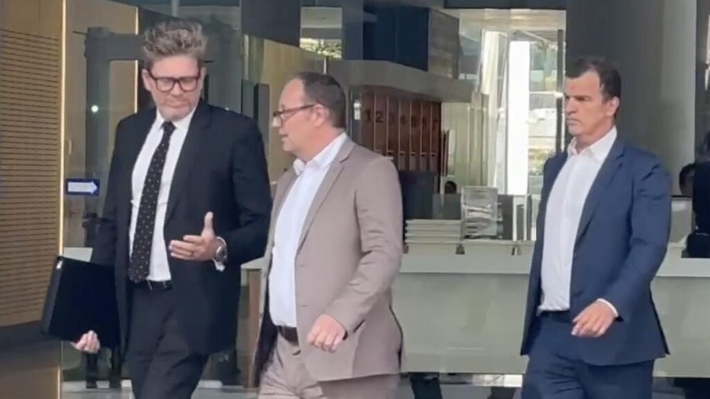 Mark Sheridan Waden (centre) is on trial accused of murdering his American girlfriend in 2018.
