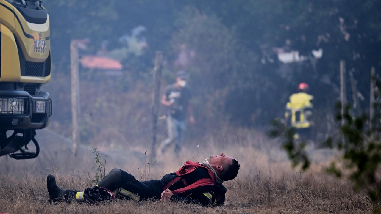 A firefighter lays on the ground near Blagon, France