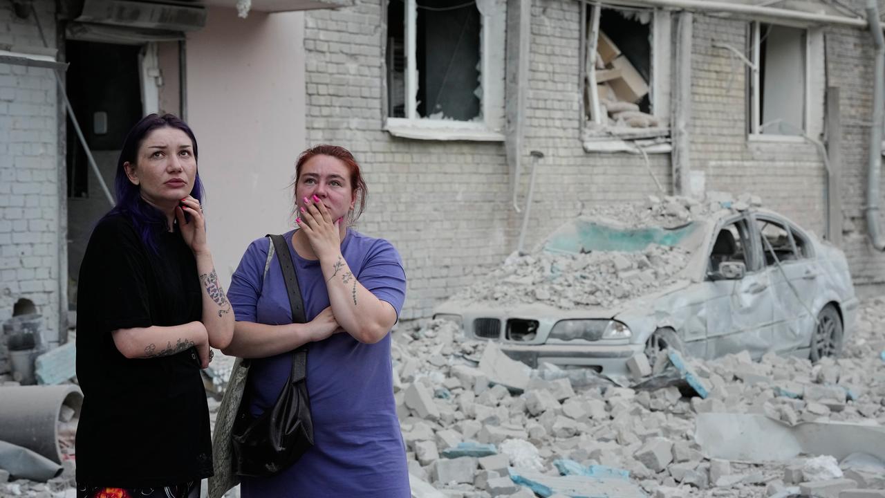 People react at the site of a Russian missile strike in Kyiv, Ukraine