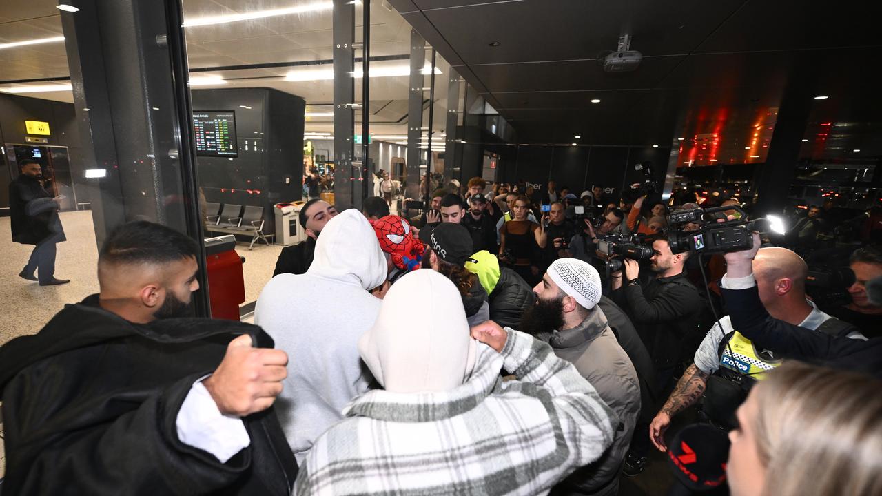 large crowd surrounds a family