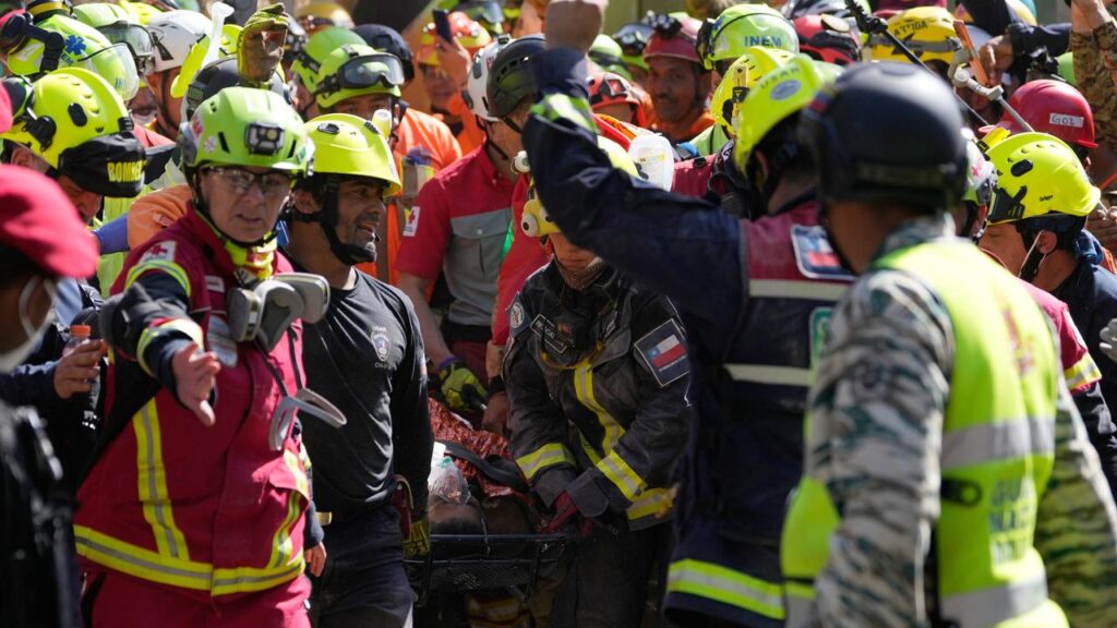 Rescue teams have pulled a man out of the rubble he was buried under for nearly eight days.
