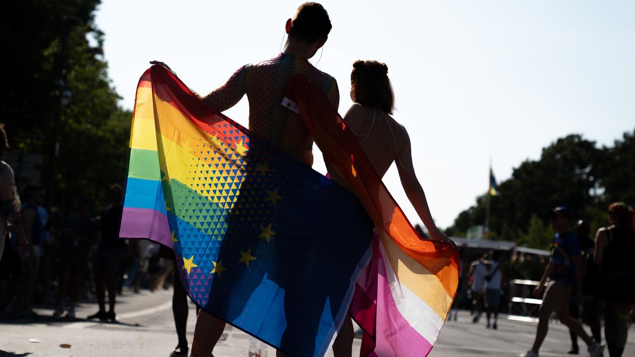 People with a rainbow flag