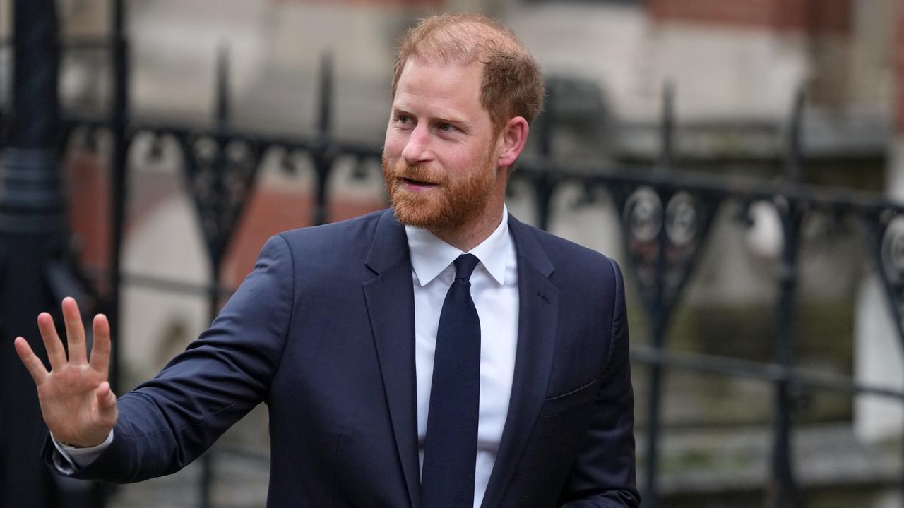 Britain's Prince Harry waves as he arrives at London's High Court