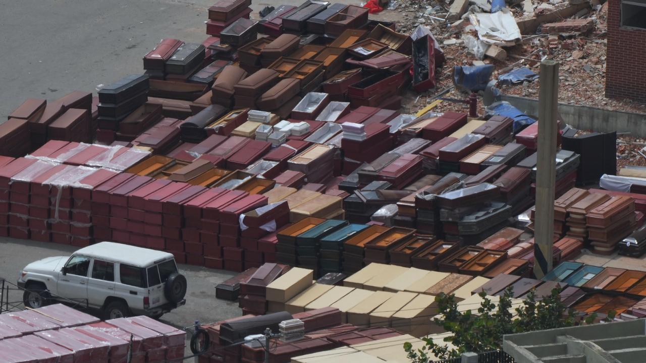 Coffins are stacked at the seaport