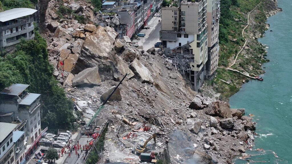 Part of a mountainside collapsed onto a residential area in China’s Chongqing on Friday.
