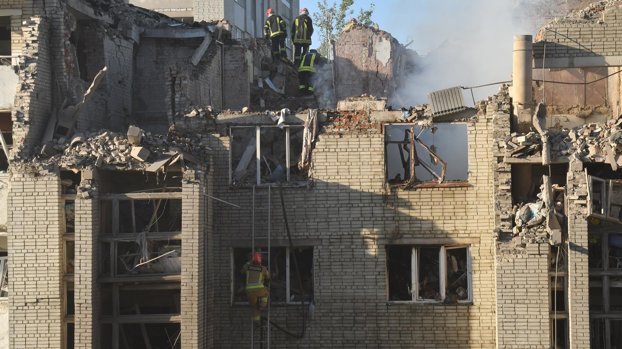 Rescuers search through the rubble of a residential building in Lviv