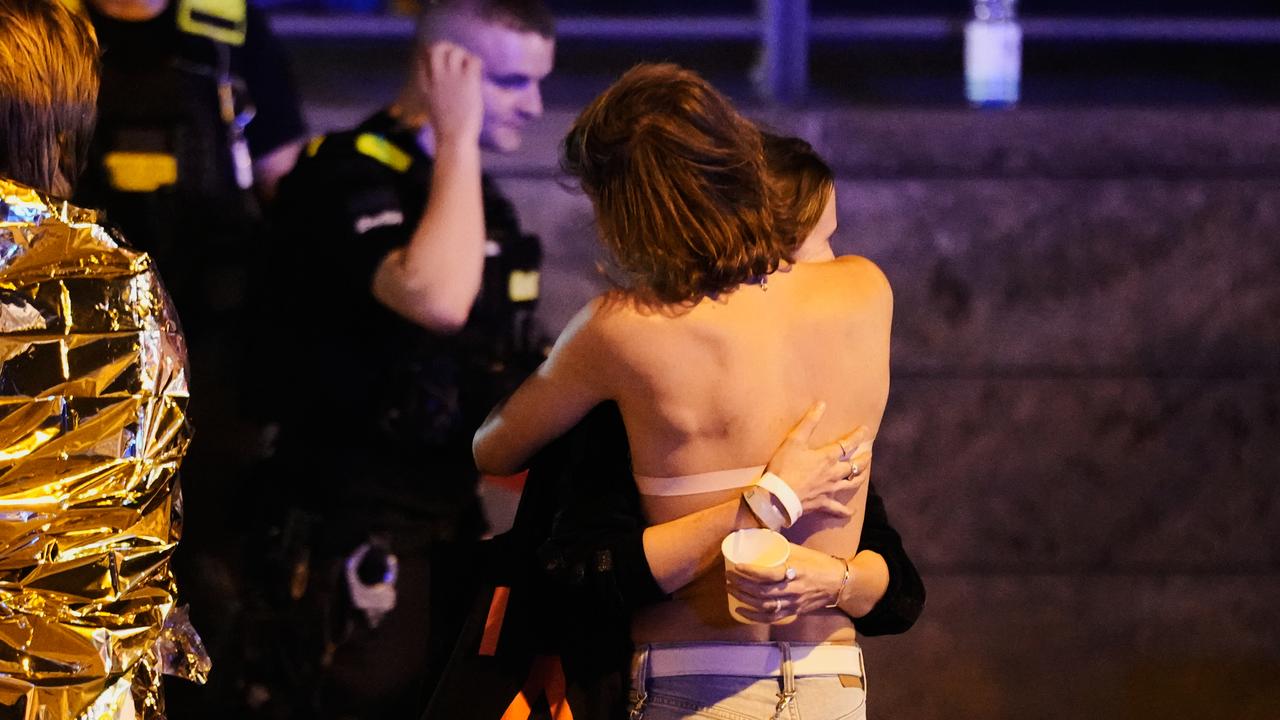 Two people embrace after the attack