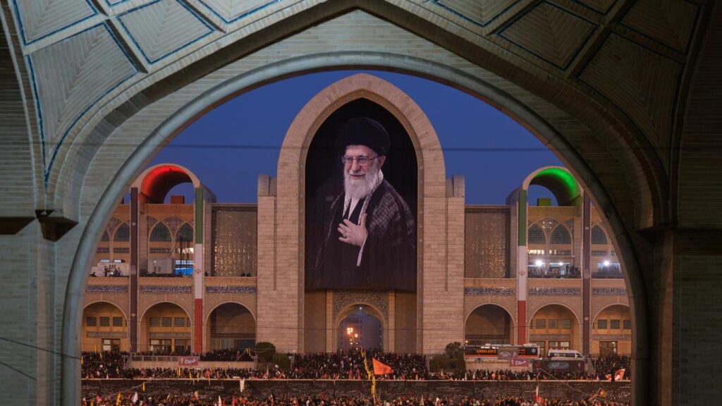 Mourners have gathered beneath a portrait of the late Iranian supreme leader Ayatollah Ali Khamenei.
