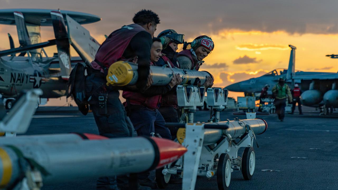 US Navy sailors moving ordnance on USS Gerald R Ford