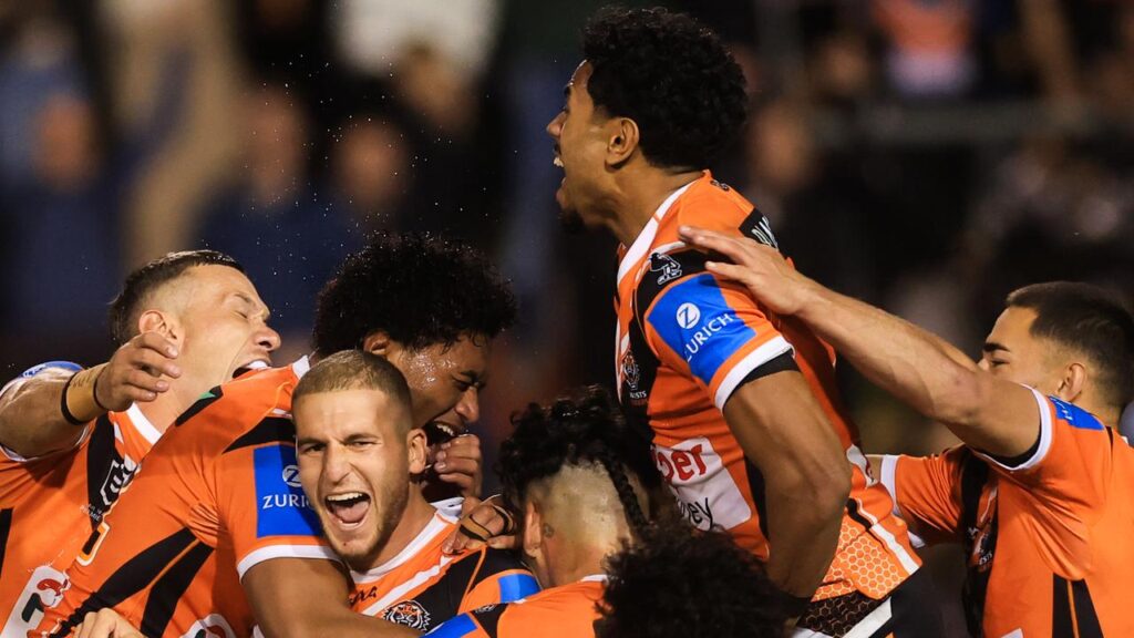 Adam Douehi (centre) has been embraced by his teammates following a tumultous time for the Tigers.
