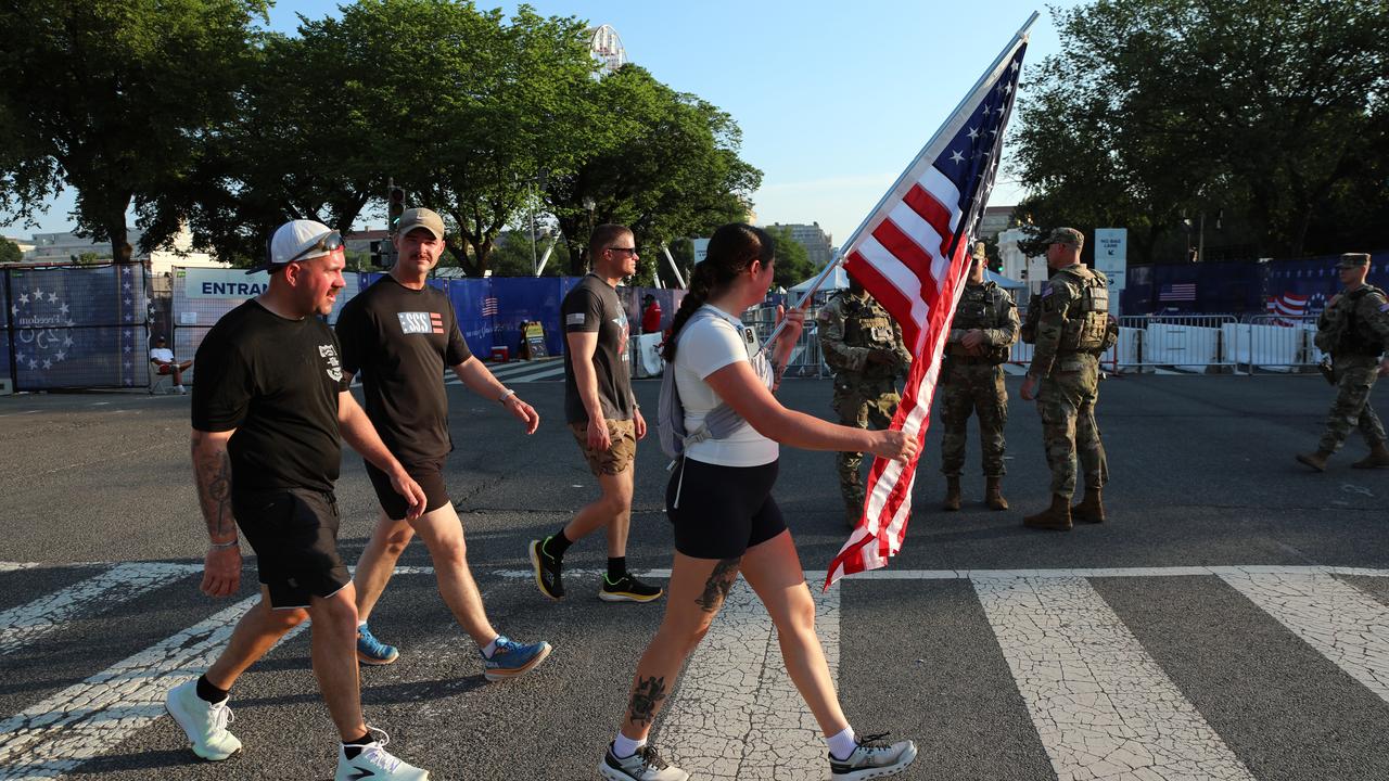 Visitor carries a US flag
