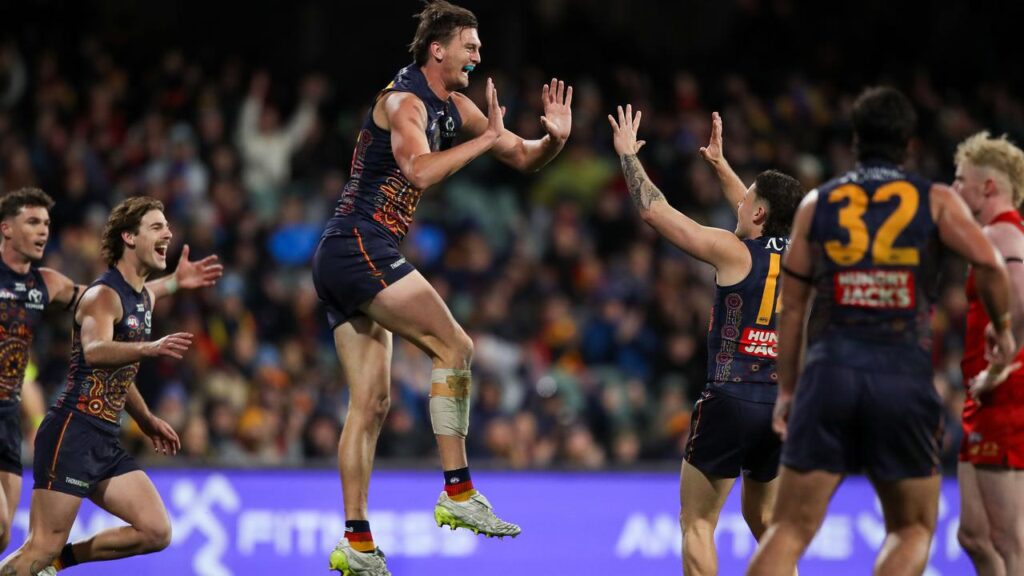 Lachlan McAndrew and his Crows teammates celebrate a goal in their big win over the Suns.
