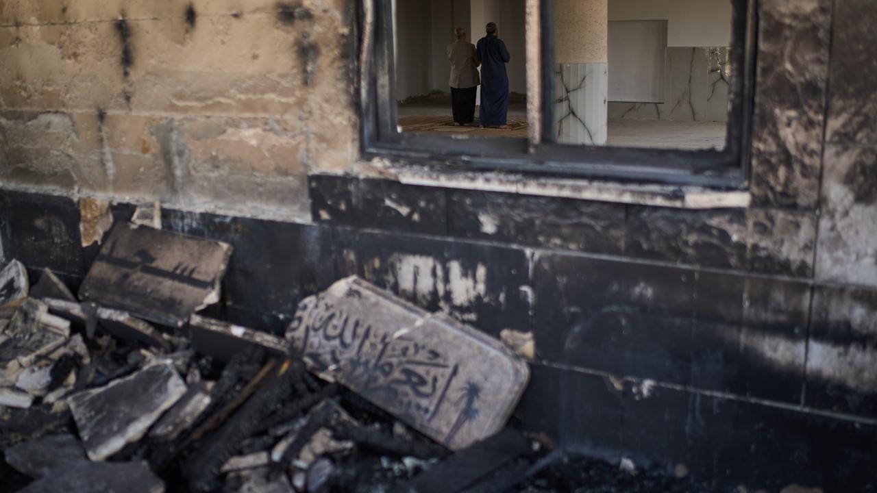 A mosque burned during an attack in the West Bank village of Qusra,