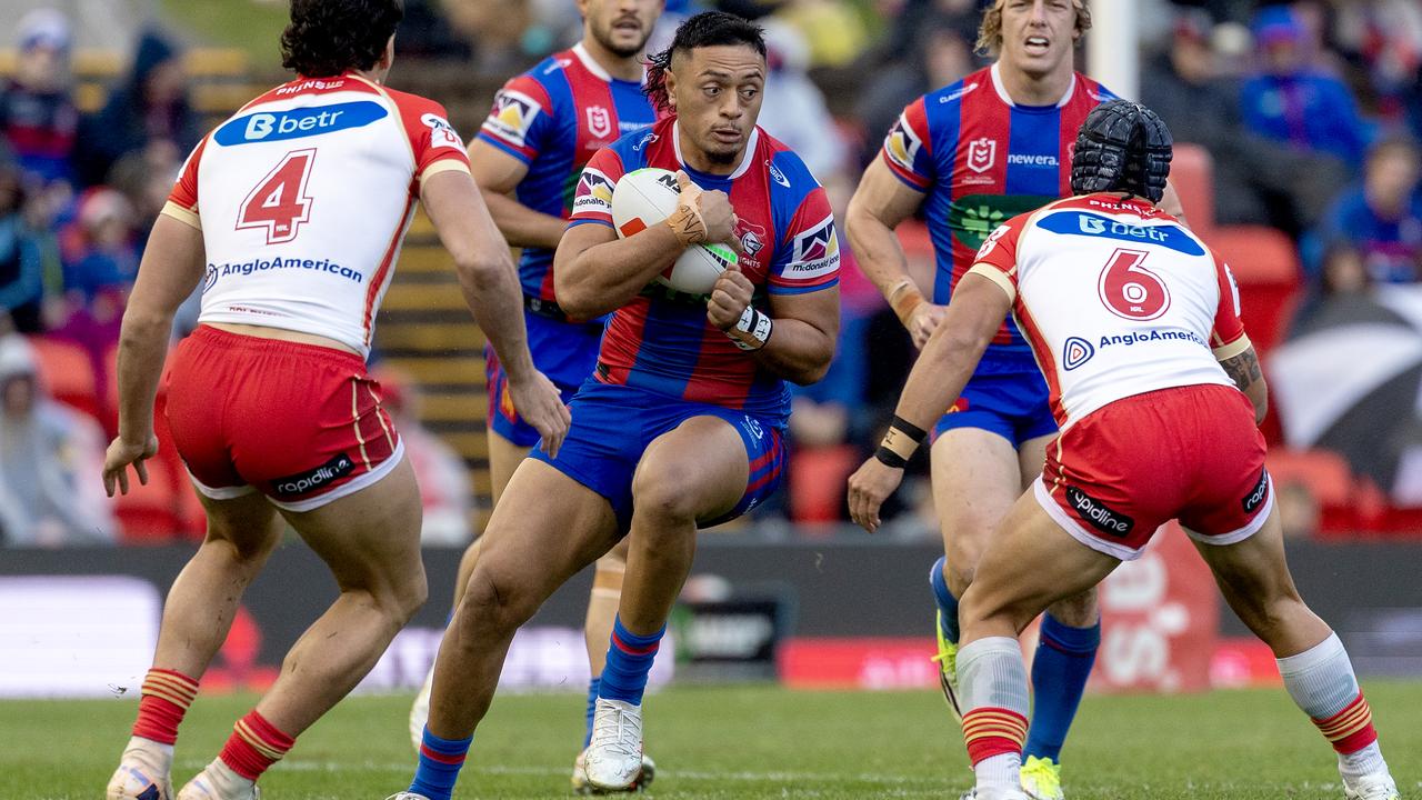 Newcastle's Jermaine McEwen looks for a way through the Dolphins.