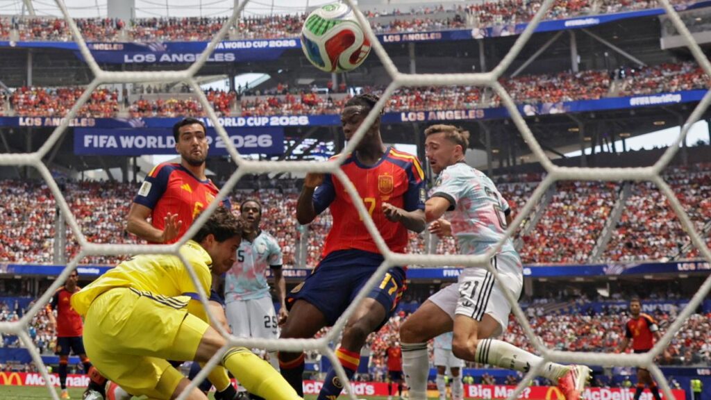Belgium keeper Senne Lammens is beaten by Mikel Merino (front left) for Spain’s winning goal.
