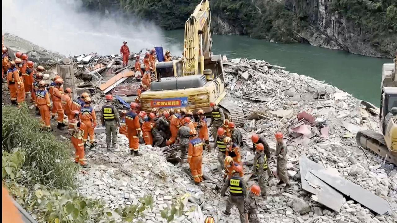 Rescuers pull a person out from the rubble